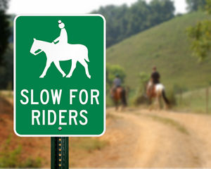 Slow for riders sign