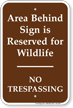 Area Behind Sign Is Reserved No Trespassing Sign